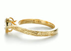 Inside band detail displaying 18K hallmark and vintage scrollwork engraving on yellow gold shank.