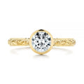 Direct top view of 2 CT round cut sparkling lab created diamond in a protective gold bezel frame.