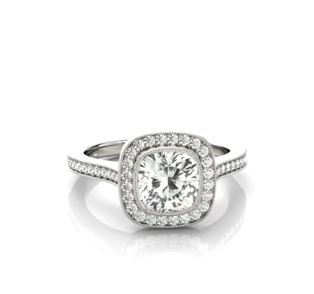 Front view of a 3 CT cushion cut lab grown diamond engagement ring with a vintage milgrain halo setting in white gold.