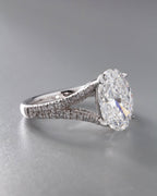 Perspective view showing the elongated 3 CT oval diamond stone and detailed double pavé row band.