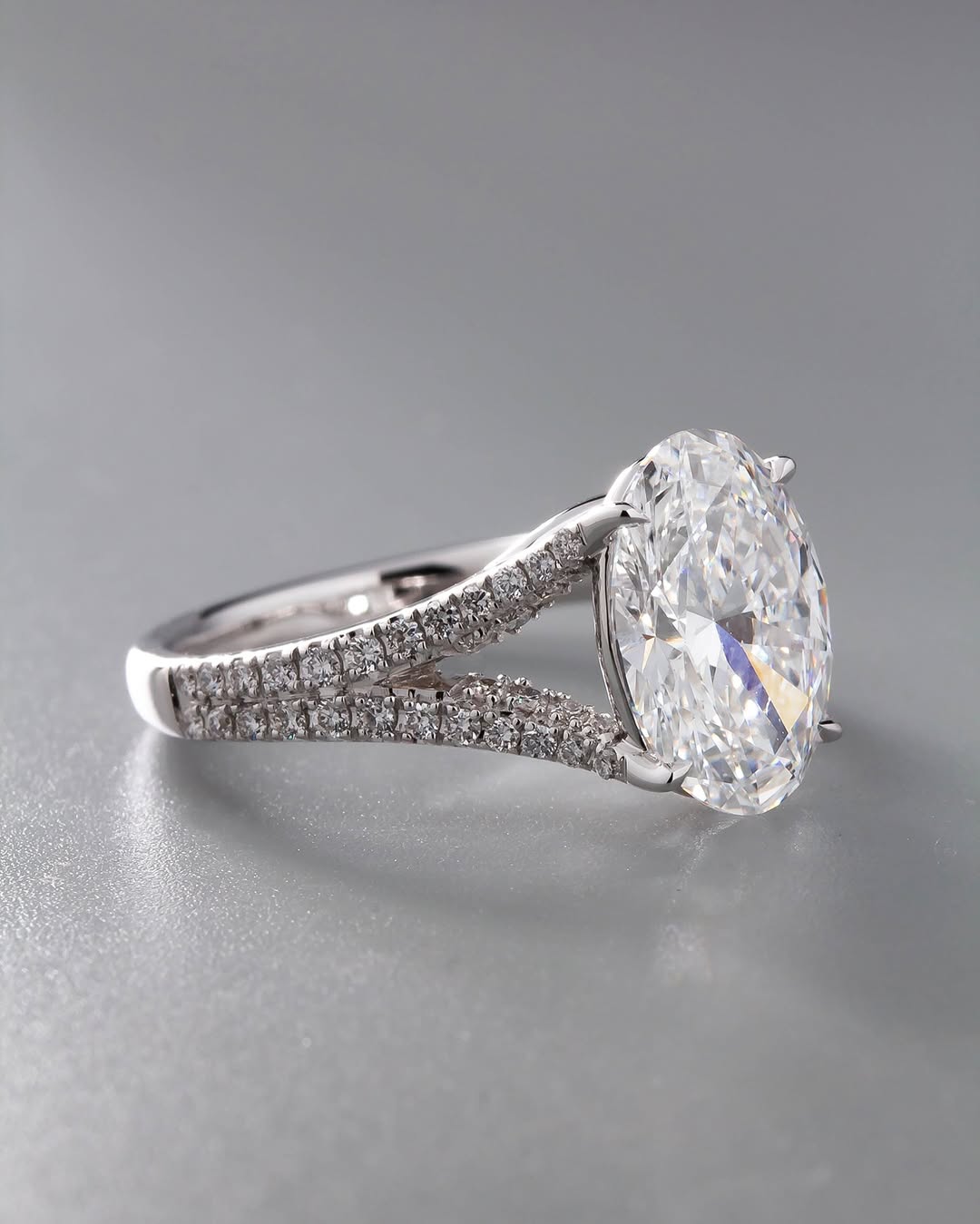 Perspective view showing the elongated 3 CT oval diamond stone and detailed double pavé row band.