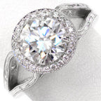Top-down view showcasing a 3 carat round cut lab diamond with a sparkling milgrain halo and hand-engraved white gold band.