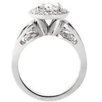 Profile side view highlighting the cathedral bridge, filigree under-gallery scrollwork, and white gold shank.