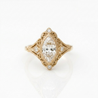 Top-down view of 3 CT marquise cut lab grown diamond in an antique filigree yellow gold setting.