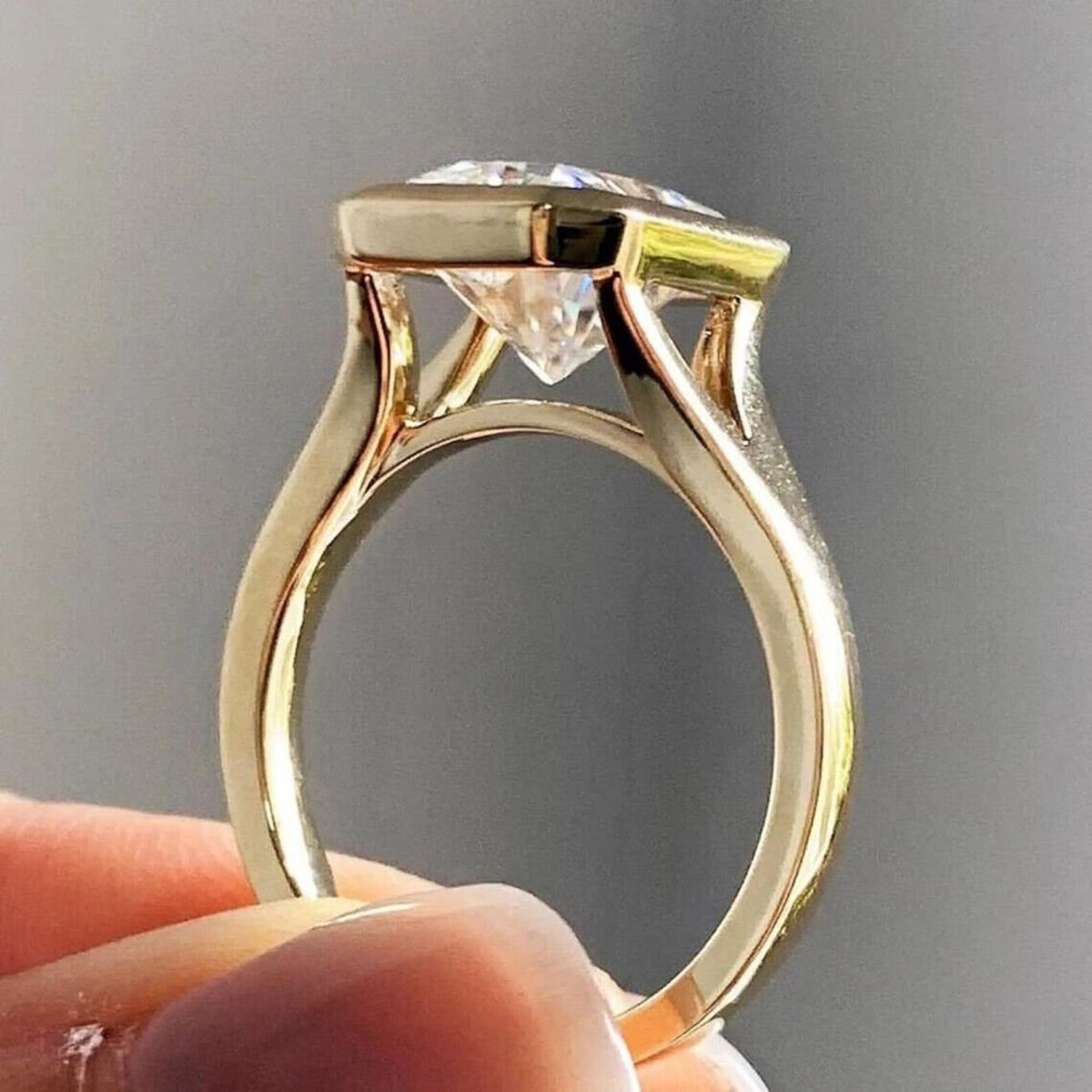 Profile shot highlighting the open gallery basket and polished band of a 4 CT radiant diamond ring.