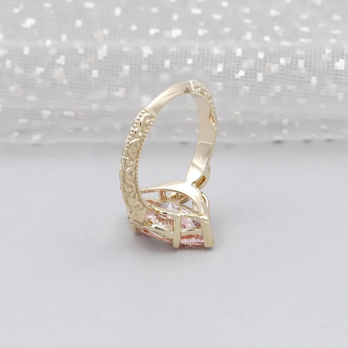 Side profile view of a 3 CT pink marquise lab grown diamond ring showcasing the vintage hand-engraved scrollwork band.