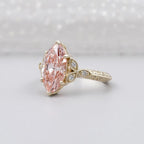 Perspective shot showing the brilliant faceting of the 3 CT blush pink marquise lab diamond in yellow gold.