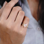 On-hand view of a woman wearing a 3 CT fancy pink marquise cut lab grown diamond vintage engagement ring.