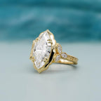 Side angle view of 4 carat marquise lab diamond vintage engagement ring worn on hand.