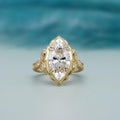 Direct top-down view of a 4 CT marquise cut lab diamond in an antique scalloped yellow gold frame.