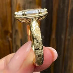 Side profile of a 4 carat oval lab grown diamond engagement ring with rose floral engraving on a yellow gold band.