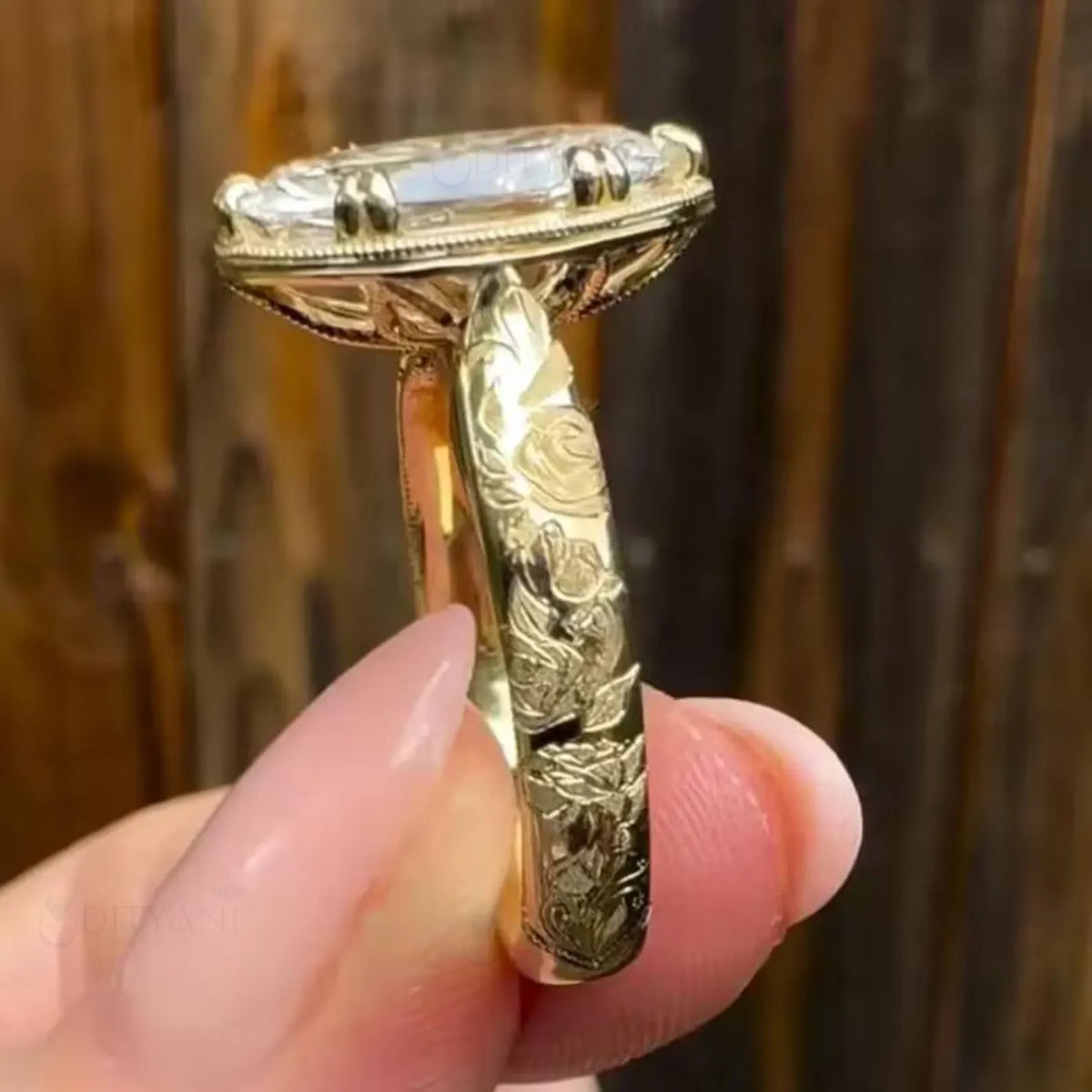 Side profile of a 4 carat oval lab grown diamond engagement ring with rose floral engraving on a yellow gold band.