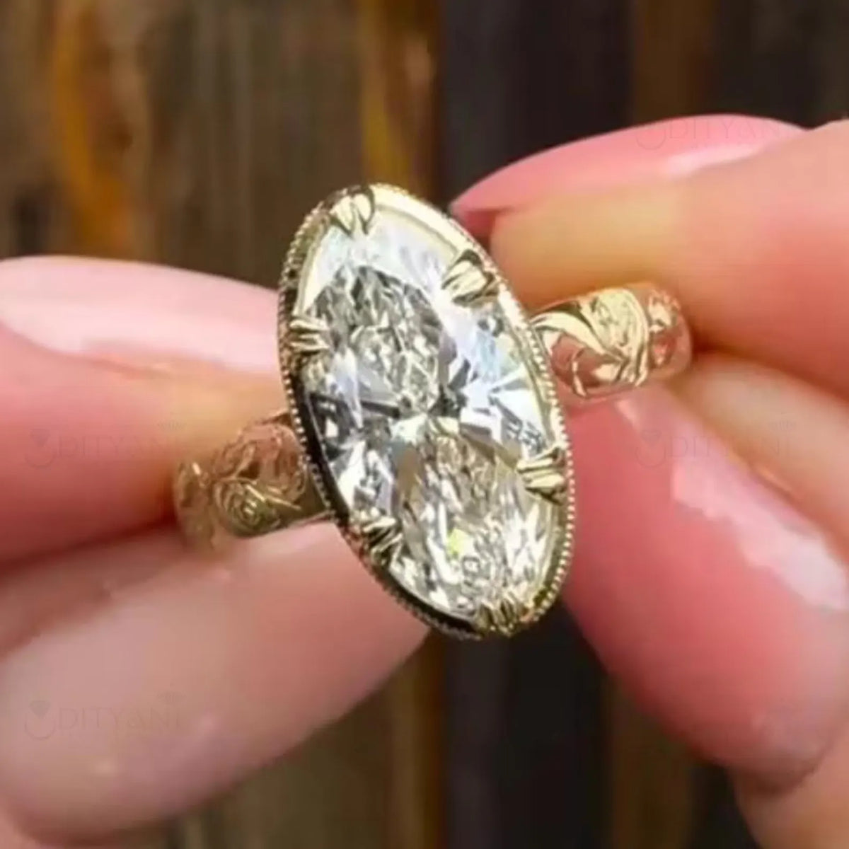 Top view of a large 4 CT oval cut lab grown diamond solitaire ring with milgrain trim and engraved yellow gold band.