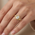 2 CT oval cut lab grown diamond bezel engagement ring with vintage scrollwork worn on hand.