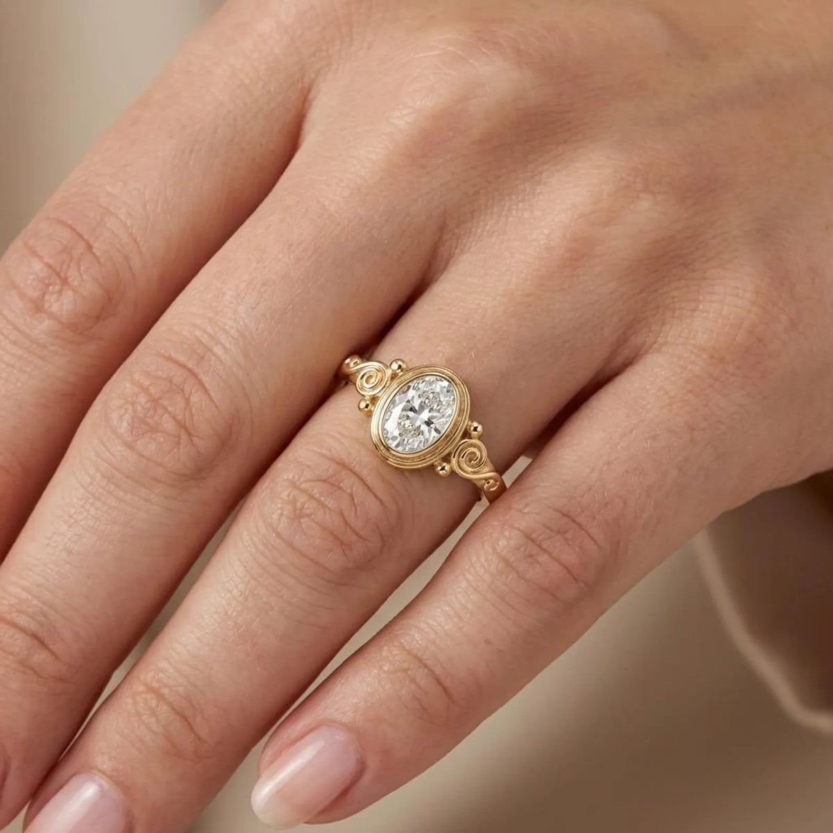 2 CT oval cut lab grown diamond bezel engagement ring with vintage scrollwork worn on hand.