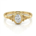 Front view of 2 carat oval lab diamond ring in yellow gold bezel setting with swirl accents.