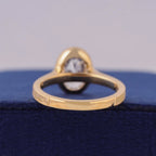 Bottom view of yellow gold ring shank showing bezel setting structural support.