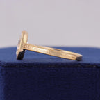 Close-up side profile displaying intricate hand-engraved scroll pattern and milgrain border on gold band.