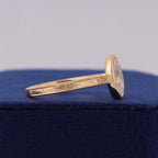 Angled studio view of 3 CT oval lab grown diamond ring showing hand-engraved shank detail.