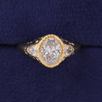 Top view of 3 CT oval lab grown diamond 3-stone signet ring with pear accents in yellow gold.