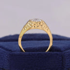 High arch side view showing dimpled texture and solid yellow gold band structure of 3 CT oval ring.