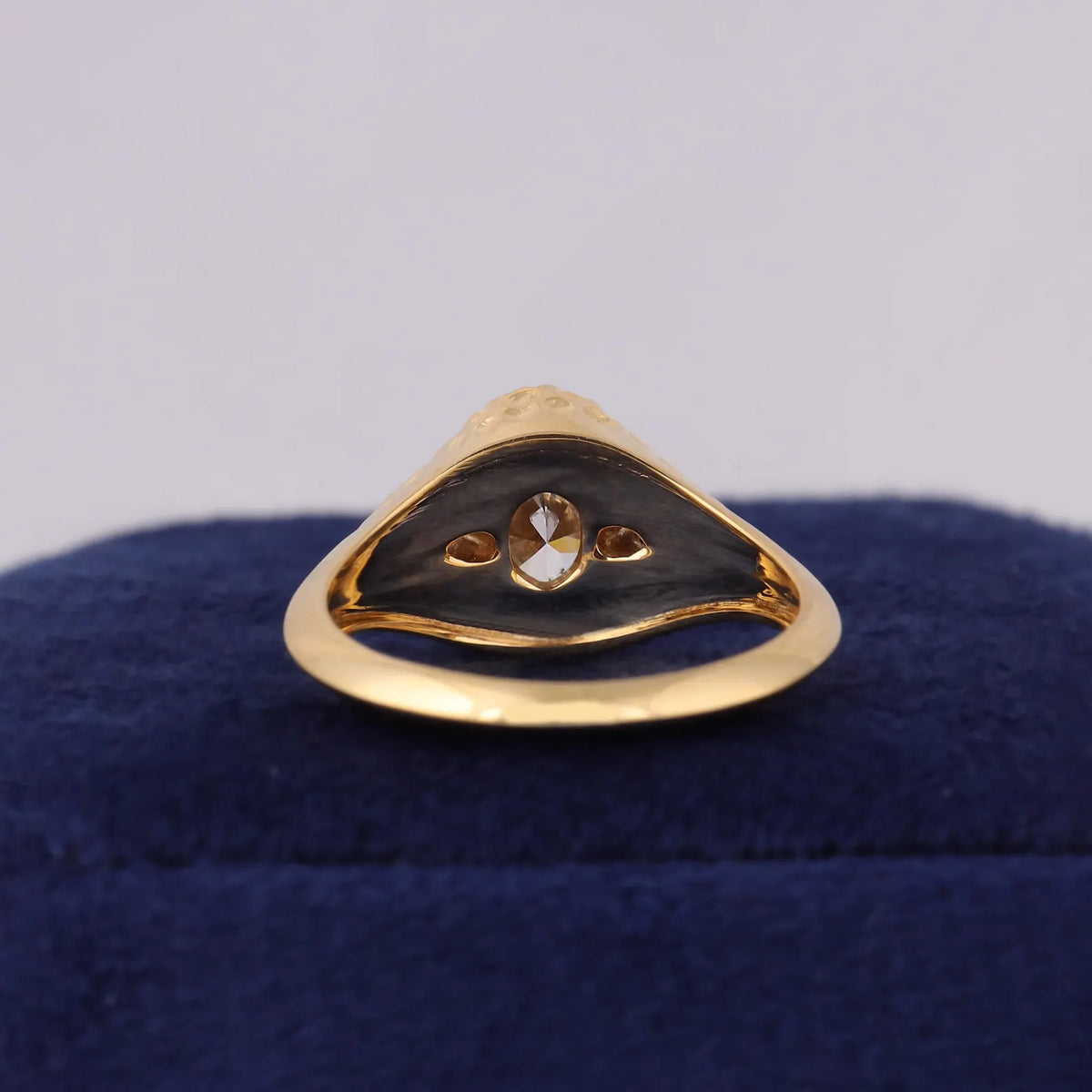 Inside band view displaying polished inner surface and light ports of 3-stone oval lab diamond ring.