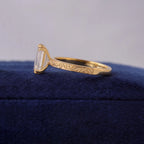 Side view of a 3 CT emerald cut lab grown diamond ring in 14K yellow gold with vintage scroll engraving.