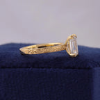 Close-up side view of 14K yellow gold ring band featuring detailed floral scrollwork engraving.