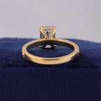 View of gold basket undergallery supporting a 3 CT emerald cut lab diamond ring.