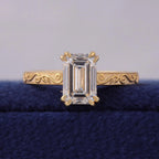 Top front view of 3 CT emerald cut lab grown diamond set on a hand-engraved yellow gold band.