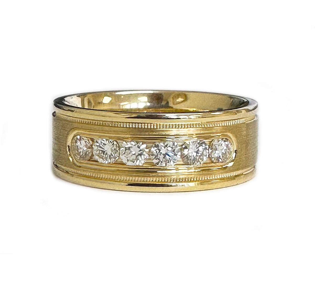 Front view of a wide gold band featuring 6 round lab-grown diamonds set in a channel with milgrain borders.