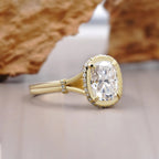 Side angled view of a 2 carat cushion cut lab grown diamond ring in gold with micro pave halo and split shank.