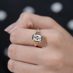 Close-up top-down view on finger showcasing the sparkling brilliance of a 2 CT cushion cut lab grown diamond.
