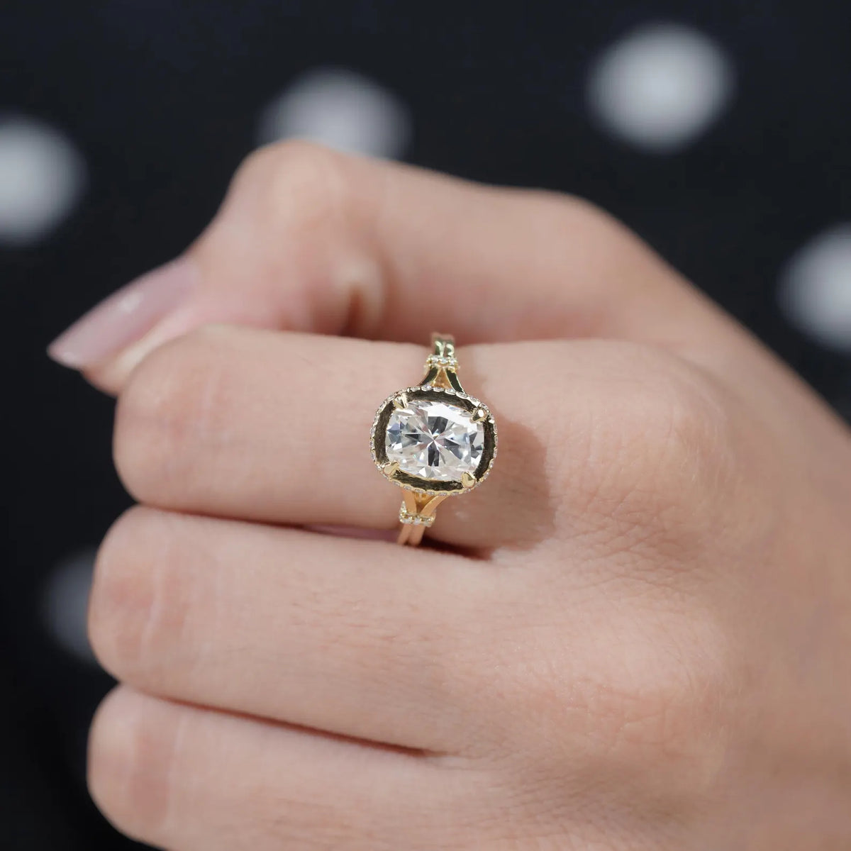 Close-up top-down view on finger showcasing the sparkling brilliance of a 2 CT cushion cut lab grown diamond.