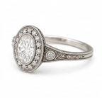Side perspective of a vintage 3 CT oval lab-grown diamond ring with milgrain halo and filigree engraved band.