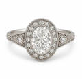 Top-down front view of a 3 CT oval cut lab diamond engagement ring featuring an intricate milgrain bezel halo.