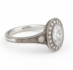 Profile view highlighting side filigree carving and accent diamond bezel on a white gold vintage band.