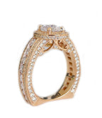 Profile view displaying intricate filigree gallery scrollwork and flat euro-shank base on a gold oval halo ring.