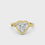 3 CT heart cut lab grown diamond engagement ring in a yellow gold bezel setting.