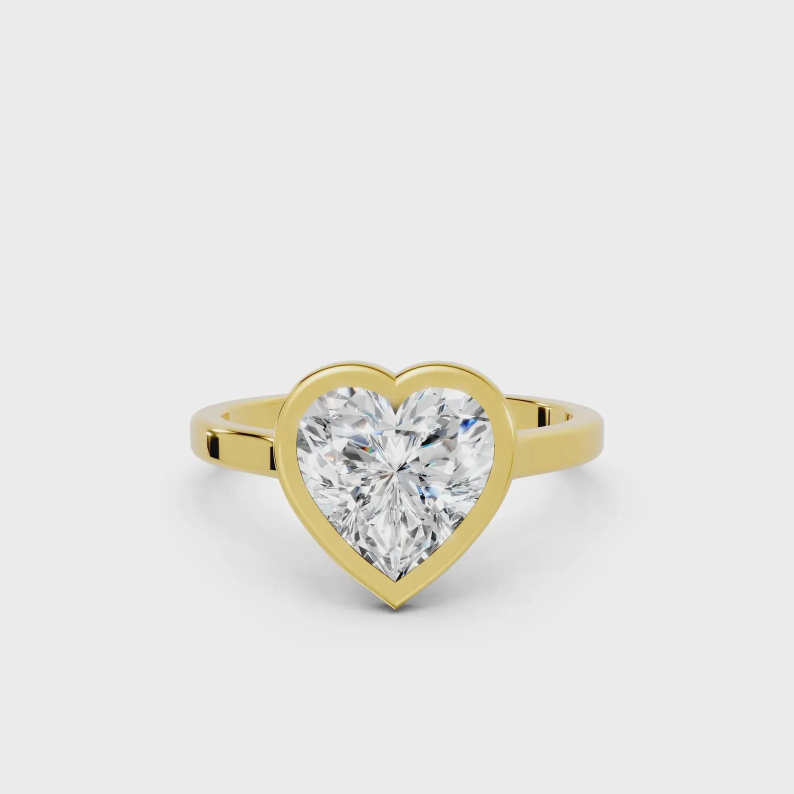 3 CT heart cut lab grown diamond engagement ring in a yellow gold bezel setting.