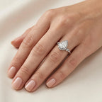 On-hand wearing view of white gold 3 CT pear lab diamond ring featuring botanical leaf band.
