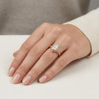 On-hand perspective of rose gold pear cut lab diamond engagement ring with organic leaf shoulders.