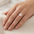 Top angle on-hand view of 3 carat pear shape lab grown diamond ring in rose gold setting.