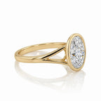 Side view of a 3 CT oval cut lab grown diamond engagement ring with split shank bezel in yellow gold.