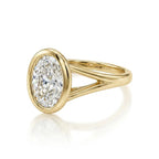 Angled side profile of a modern yellow gold bezel engagement ring holding a 3 carat oval lab diamond.