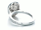 Underneath perspective showcasing the intricate scrollwork filigree gallery supporting the main oval diamond setting.