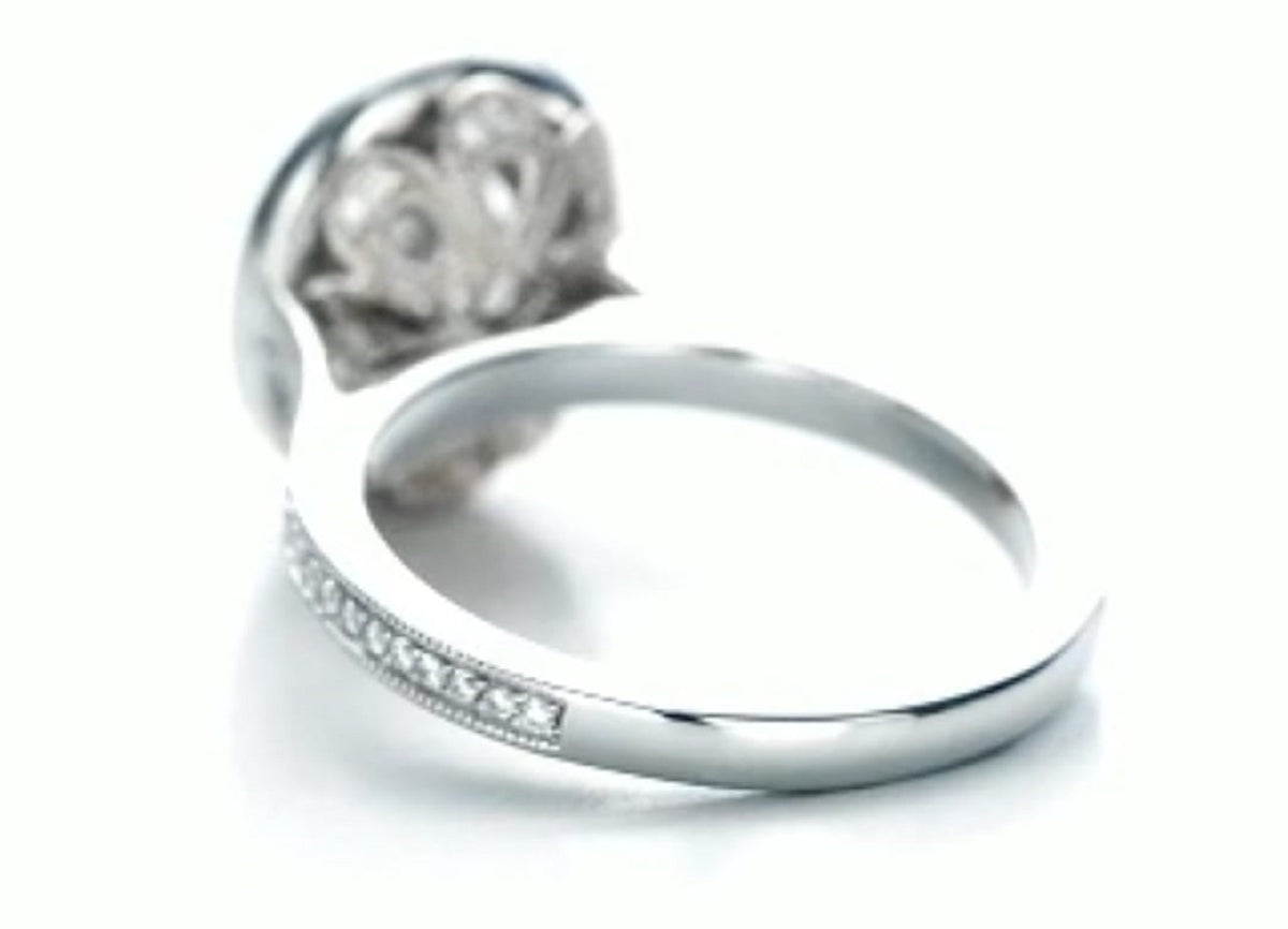 Underneath perspective showcasing the intricate scrollwork filigree gallery supporting the main oval diamond setting.