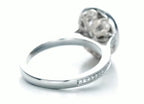 Close-up view of the handcrafted floral filigree basket underneath the 3ct oval lab diamond halo.