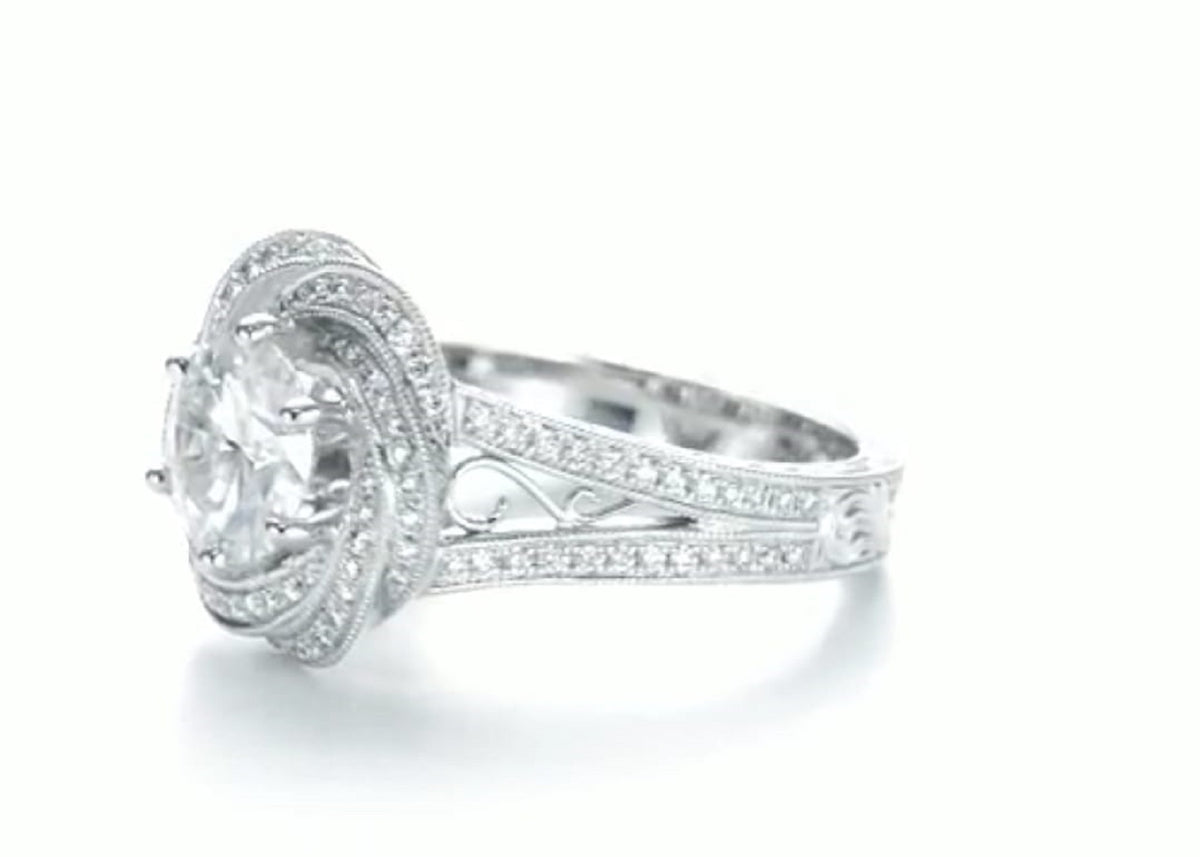 Side view highlighting the openwork filigree split shank and floral swirl halo profile.