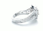 Perspective shot showcasing the 18K hallmark stamp, filigree gallery, and side engraving on the ring band.
